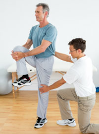 therapist helping patient with balance exercise